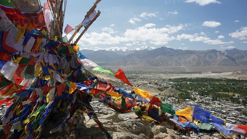 Colourful prayer flags flutter high above a vast mountain landscape, Ladakh, North India, Himalayas, India