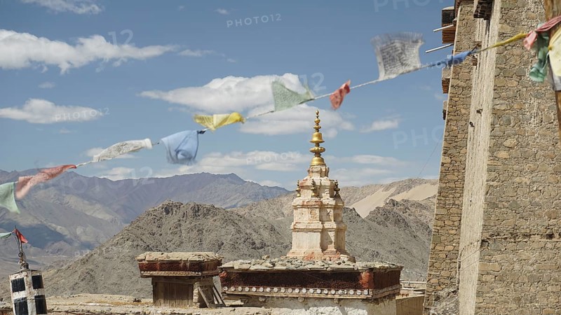 Traditional tower with prayer flags and mountain scenery in the background near Leh, Ladakh, North India, Himalayas, India