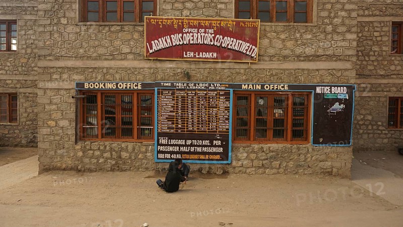 Ladakh bus operator cooperative stone building with signs and street view, Leh, Ladakh, North India, Himalayas, India