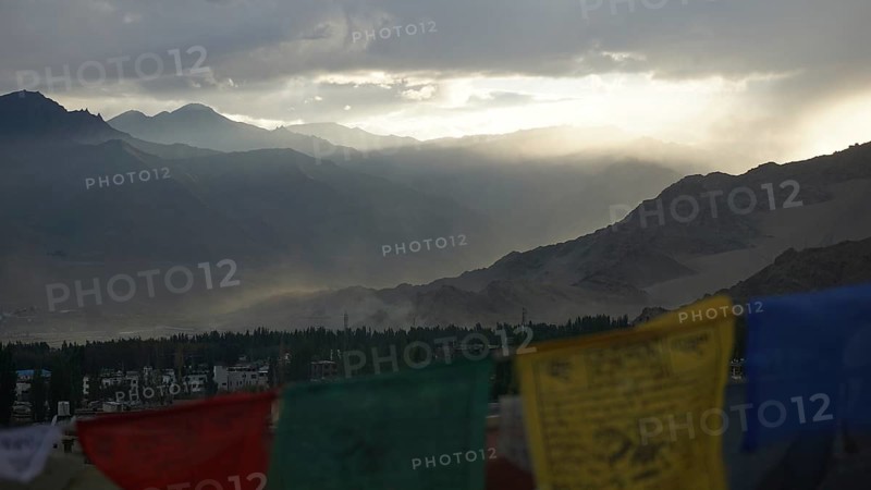 Prayer flags in foreground, mountains in sunset haze, Leh, Ladakh, North India, Himalayas, India