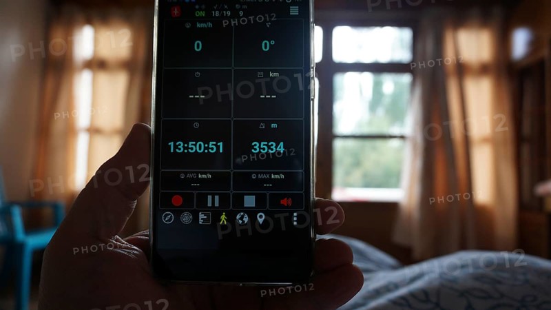 View of a smartphone showing altitude, interior view of a bedroom, Leh, Ladakh, North India, Himalayas, India