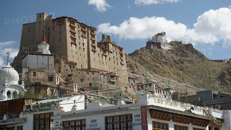 Historic buildings with Leh Palace and temples against a mountainous landscape under blue sky, Ladakh, North India, Himalayas, India