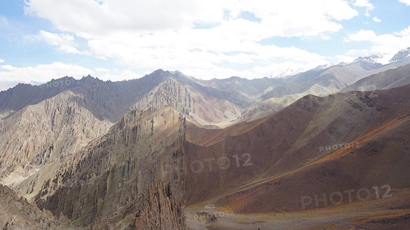 Mountain landscape with steep peaks and clear, beautifully illuminated area, trekking at Stok La Pass in Ladakh, Himalayas, India