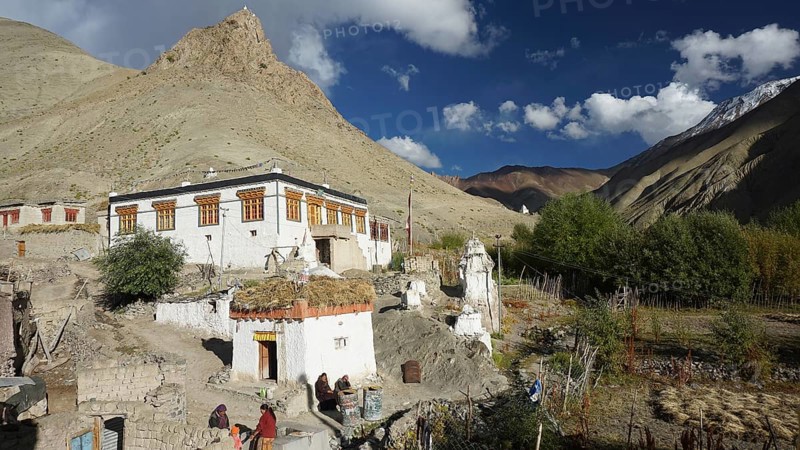 Traditional mountain village with colorful buildings under cloudy sky, trekking in Ladakh, Himalayas, India