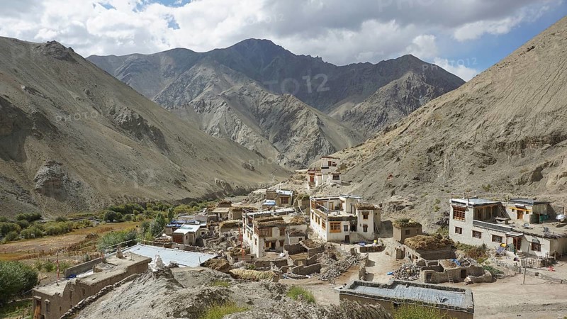 Traditional village in a mountain valley surrounded by magnificent mountains, trekking in Ladakh, Himalayas, India