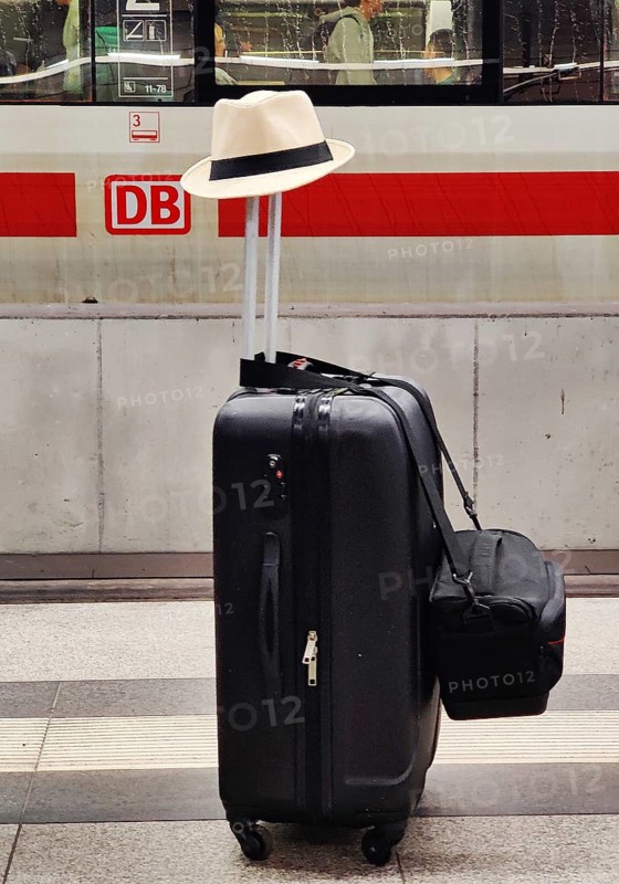 Luggage left alone with hat on platform in front of Intercity Express ICE, Berlin Central Station, Germany