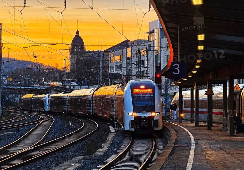 Incoming regional express RE 4 to Dortmund Hbf and inetrCityExpress ICE at Wuppertal main station in the evening, North Rhine-Westphalia, Germany