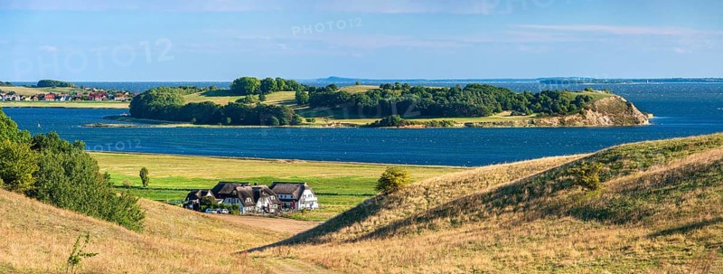 Hilly landscape in the Zicker Mountains, including Zicker Alps, view across the lagoon landscape to the Klein Zicker peninsula, thatched houses in front, Mönchgut nature reserve, Gross Zicker, Mönchgut peninsula, Rügen island, Mecklenburg-Western Pomerania, Germany
