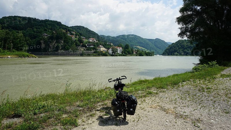Cycling on the banks of the Danube with rolling hills and clouds, cycling on the long-distance cycle path, Danube cycle path, Austria
