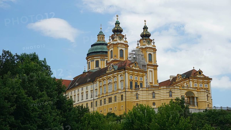 Baroque monastery in Melk surrounded by trees and sky, Melk, Austria
