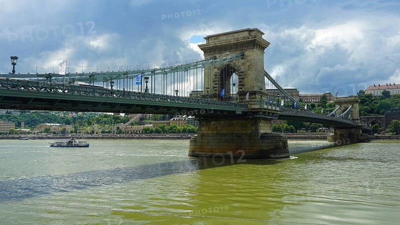 The Szechenyi Chain Bridge across the Danube under a cloudy sky, connection between Buda and Pest, Budapest, Hungary