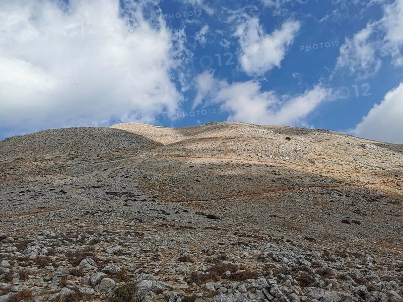 View of rocky hills on Tahtali Dagi under a partly cloudy sky, climbing Tahtali Dagi, Lycia, Turkey