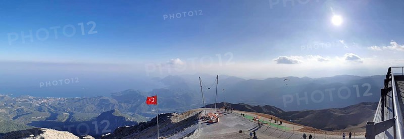 Panorama at the summit of Tahtali Dagi, extensive mountain landscape with a Turkish flag and clear sky, ascent of Tahtali Dagi, Lycia, Turkey