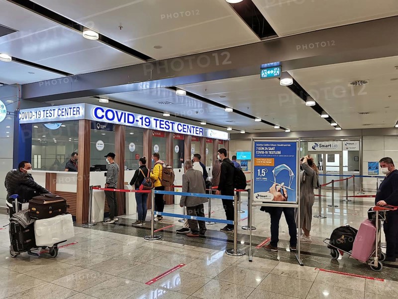 People are standing in a queue in front of a COVID-19 test center at the airport, Antalya, Turkey during corona