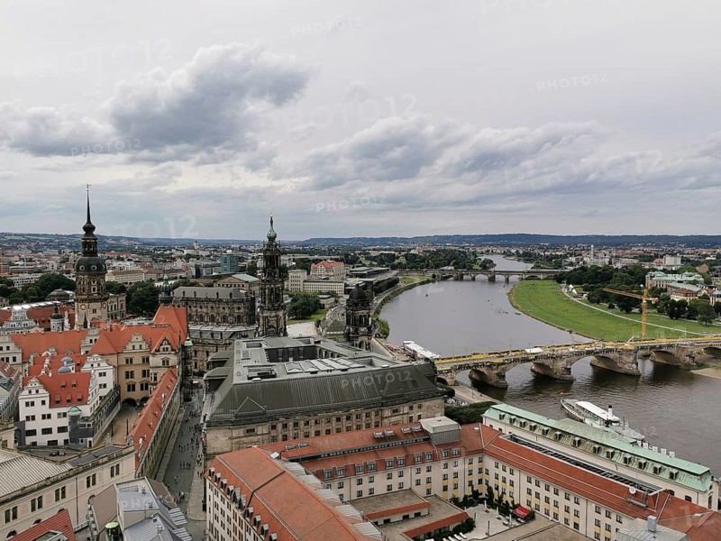 View of Dresden on the Elbe with bridge and historic buildings under cloudy sky, Dresden