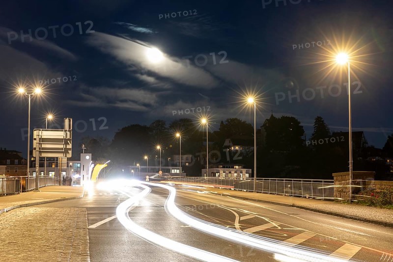 Night scene at the old Elbe bridge with traffic, lanterns and full moon, Meissen, Saxony, Germany