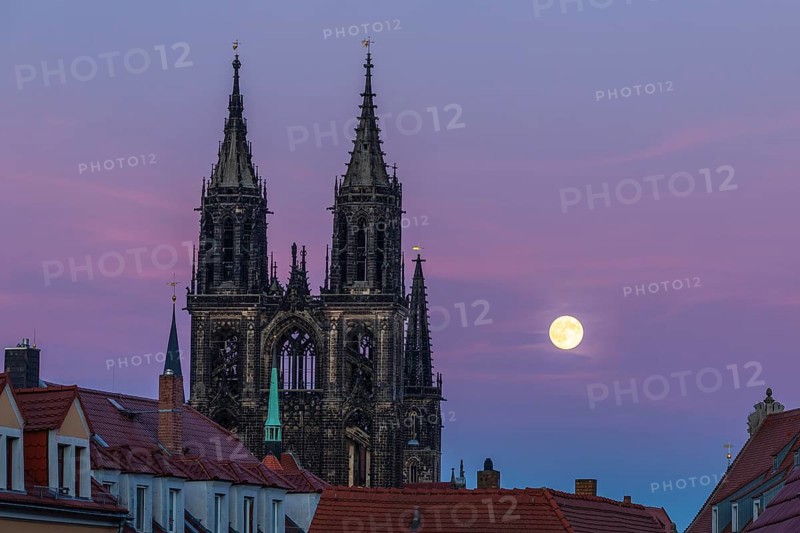 Full moon next to the cathedral towers at blue hour in Meissen, Saxony, Germany