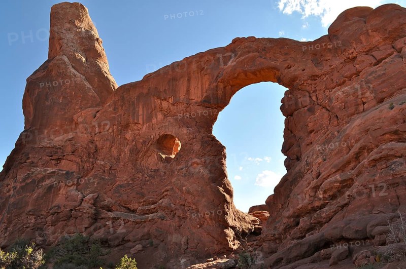 Turret Arch, an impressive sandstone rock arch under a clear blue sky, formed by natural erosion, Arches National Park, Utah, USA