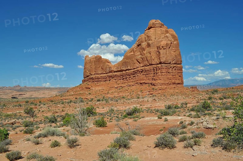 Large, eroded rock formation in a dry, open area of land, Arches National Park, Utah, USA