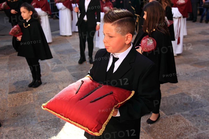 Sicily, Trapani, Good Friday mystery procession La Processione dei Misteri, groups accompany the procession with the mysteries, boy with a red pillow on the nails of the cross of Christ, symbolic