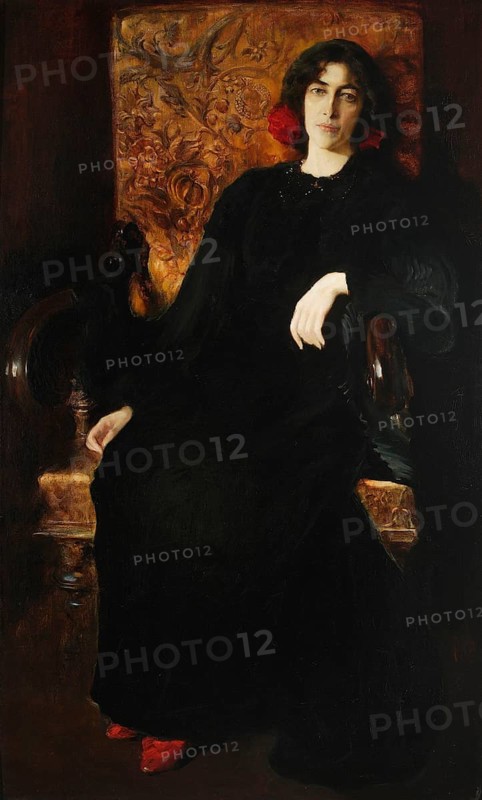Kazimierz Stabrowski (b. 21 November 1869, d. 10 June 1929 in Garwolin), Polish painter: portrait of Julia Stabrowska née Janiszewska, artist's woman (in front of 1908), Portrait of Julia Stabrowska, née Janiszewska, woman of the artist (in front of 1908), authentic, digitally restored reproduction from an original from the early 20th century, exact date unknown, Historic, Elegant portrait of a woman in a dark dress and red shoes, sitting on a decorated armchair. century, exact date of depiction unknown, Historical, Elegant portrait of a woman in a dark dress and red shoes, sitting on an ornate armchair