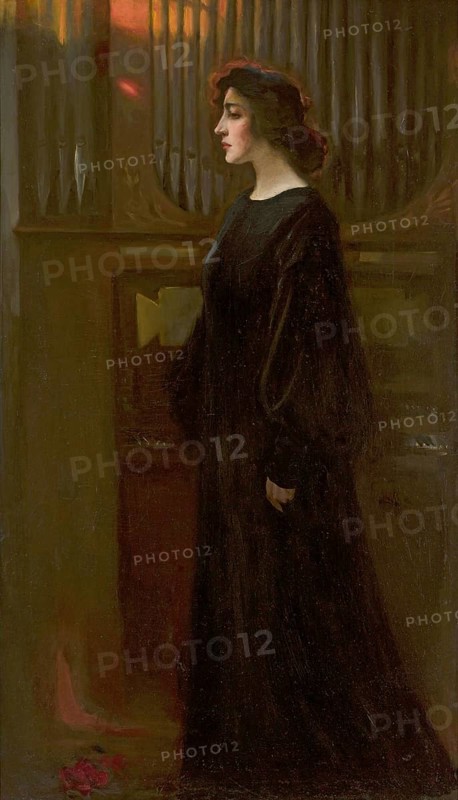Kazimierz Stabrowski (b. 21 November 1869, d. 10 June 1929 in Garwolin), Polish painter: portrait of Laura Pytlinska (in front of 1910), Portrait of Laura Pytlinska (in front of 1910), authentic, digitally restored reproduction from a model from the early 20th century, exact date of depiction unknown, Historical, A woman stands elegantly in front of an organ in a dark, melancholy interior