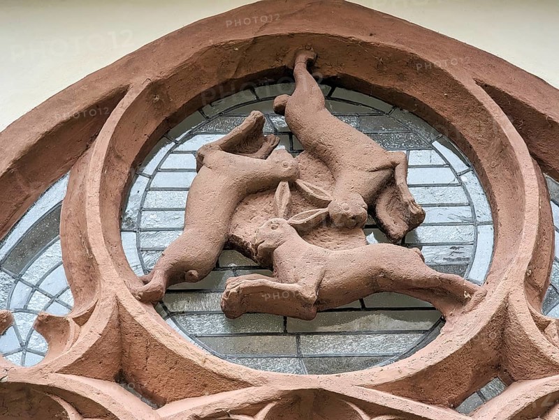 Hare window, three-hare window, optical illusion, three hares running in circles, ears, symbol of Holy Trinity, eternal cycle, famous landmark in the cloister, late Gothic, Paderborn Cathedral, Paderborn, Germany