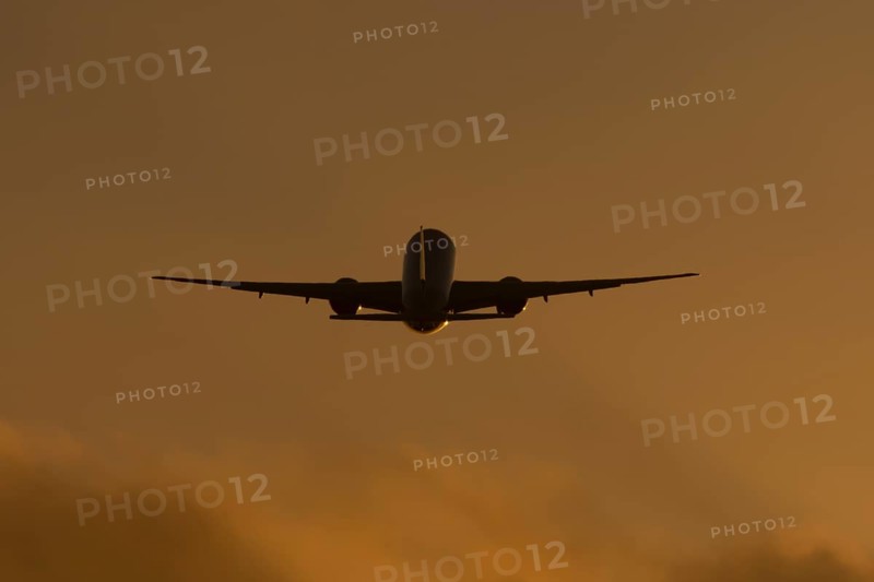 Boeing 777 A7-BFL commercial jet aircraft of Qatar cargo taking off in flight silhouette at sunset at London Stansted airport, Essex, England, United Kingdom