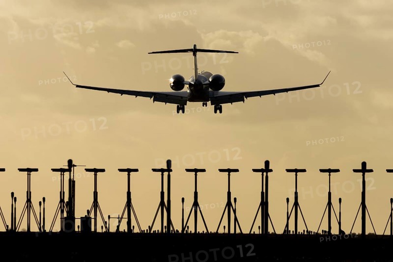 Gulfstream executive business jet aircraft in flight on approach to land at sunset at London Stansted airport, Essex, England, United Kingdom