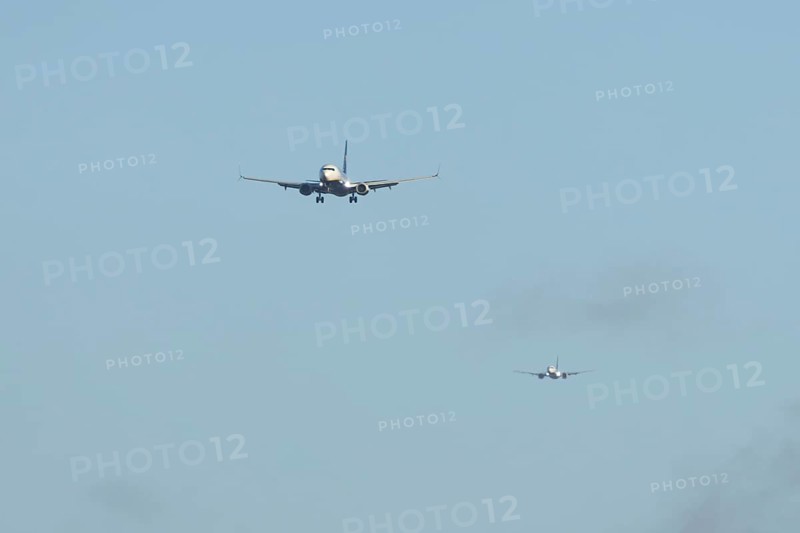 Boeing 737 two commercial passenger airliner jet aircraft of Ryanair airways in flight on approach to land at London Stansted airport, Essex, England, United Kingdom
