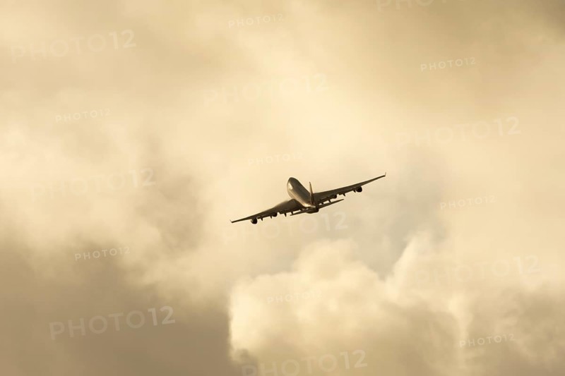 Boeing 747-400 jumbo jet LX-TCV commercial aircraft of Cargolux cargo in flight silhouette at sunset at London Stansted airport, Essex, England, United Kingdom