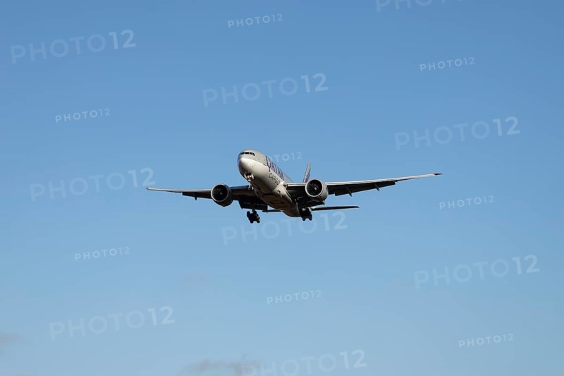 Boeing 777 commercial jet aircraft of Qatar cargo in flight on approach to London Stansted airport, Essex, England, United Kingdom