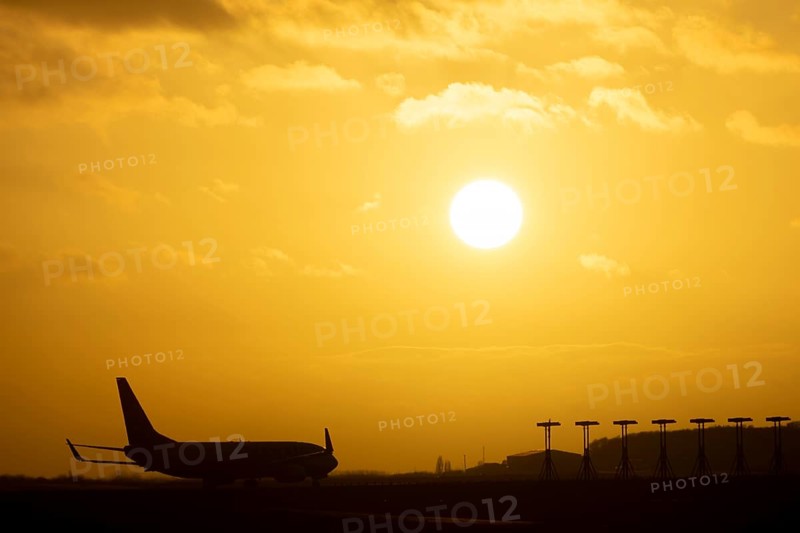 Boeing 737 commercial passenger airliner jet aircraft of Ryanair airlines moving onto the runway to take off at sunset at London Stansted airport, Essex, England, United Kingdom