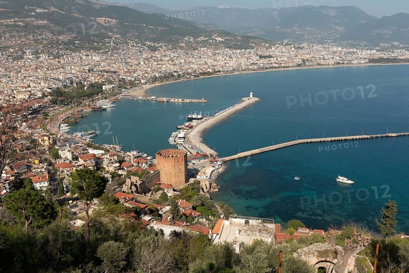 Alanya, Turkey. April 7th 2021 Landscape view of Alanya Harbour and the Red Tower with the Taurus Mountains and Mediterranean sea, Turkey