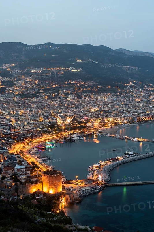 Alanya, Turkey. April 6th 2021 Beautiful portrait of Alanya Harbour and the Red Tower at night with the Taurus Mountains and Mediterranean Sea, Turkey