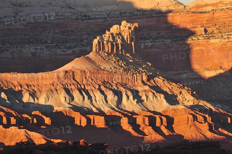 Rock formation in evening light with dramatic shadows in a barren desert landscape, Capitol Reef National Park, Utha, USA
