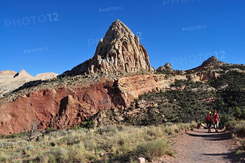 Proud rock formation rising above migrating people, Capitol Reef National Park, Utha, USA