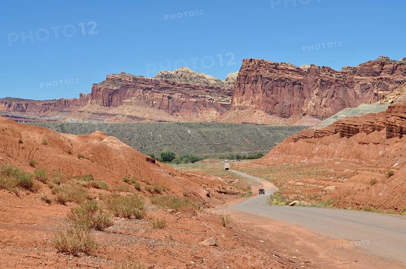 Extensive road through a landscape of red rocks and clear blue sky, Capitol Reef National Park, Utha, USA