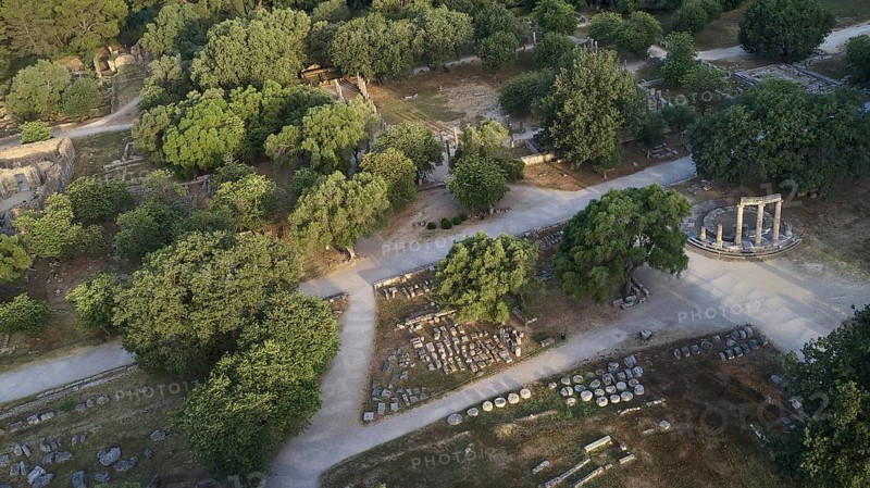 Soft morning light, Philippeion, ancient ruins and a round temple surrounded by trees and paths, drone shot, archaeological site, Ancient Olympia, Olympia, Peloponnese, Greece
