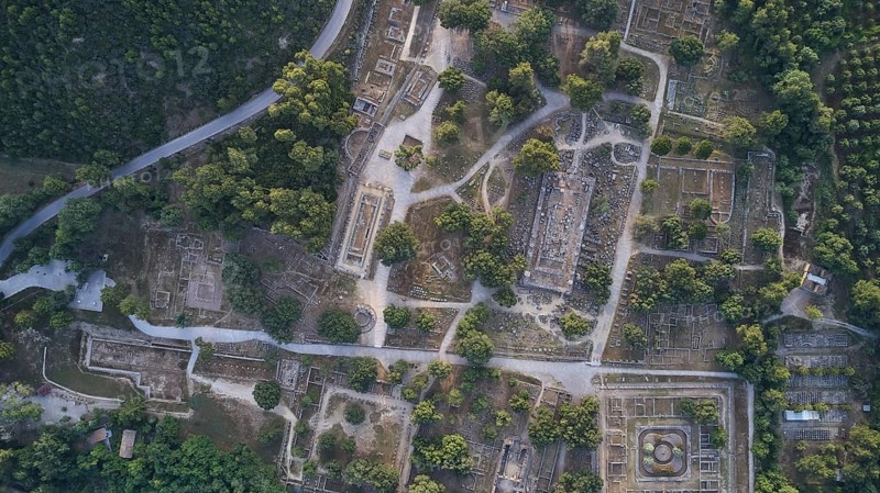 Olympic excavation site from high altitude, Temple of Zeus, Temple of Hera, Leonidaion, Palestra Philippeion, etc. Aerial view of ancient ruins between thick greenery and clear paths, drone shot, archaeological excavation site, Ancient Olympia, Olympia, Peloponnese, Greece