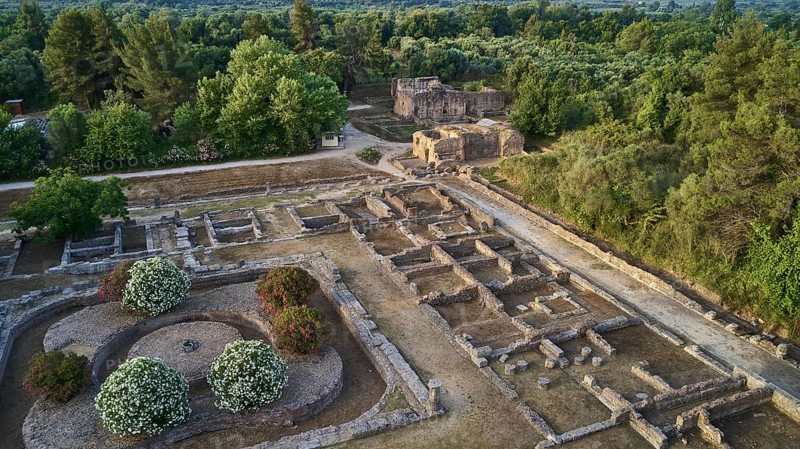 Soft morning light, part of Leonidaion, archaeological remains with foundations and surrounding lush vegetation, drone shot, archaeological site, Ancient Olympia, Olympia, Peloponnese, Greece