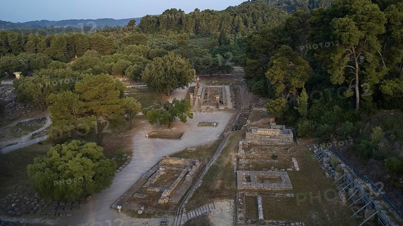 Soft morning light, Temple of Hera, ruins and thick forests in hilly surroundings, drone shot, archaeological site, Ancient Olympia, Olympia, Peloponnese, Greece