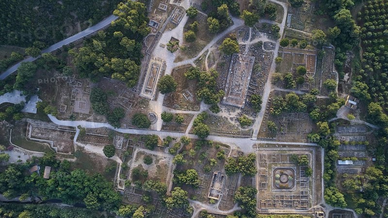 Olympic excavation site from high altitude, Temple of Zeus, Temple of Hera, Leonidaion, Palestra Philippeion, etc. Aerial view of an extensive ancient site with ruins and lush vegetation, drone shot, archaeological excavation site, Ancient Olympia, Olympia, Peloponnese, Greece