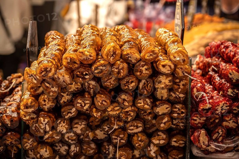 A colorful display of Cevizli Sucuk-Sweet Turkish Rolls made from Grape Molasses and Walnuts, for sale in a street bazaar in Istanbul, Turkey