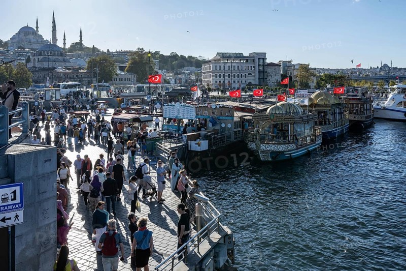 Istanbul, Turkey. September 18th 2025. Panorama view of the busy Eminonu district beside the Golden Horn and boats selling Balik Ekmek a popular fish sandwich street food near the Egyptian Bazaar and Galata Bridge