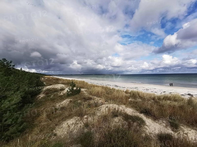 Quiet beach with clouds in the sky and dunes in the foreground, Rügen, Baltic Sea