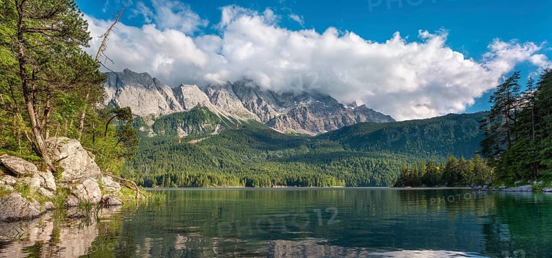 View over Lake Eibsee lake, the Wetterstein Mountains with the Zugspitze in the background, clouds moving across the peaks, Grainau, Garmisch-Partenkirchen, Bavaria, Germany