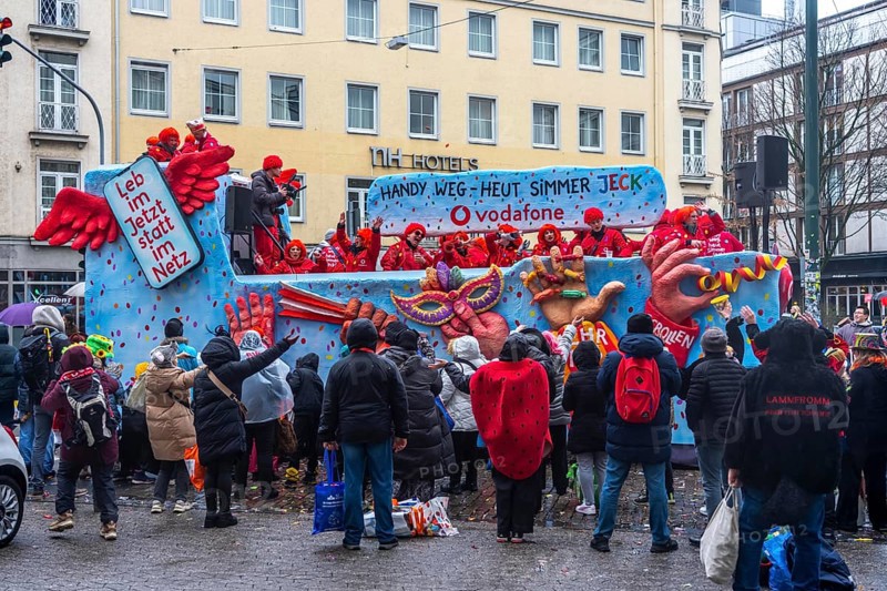 Rose Monday procession in Düsseldorf, theme car from companies, here wholesale company Vodafone, at the street carnival, in some heavy rain, North Rhine-Westphalia, Germany
