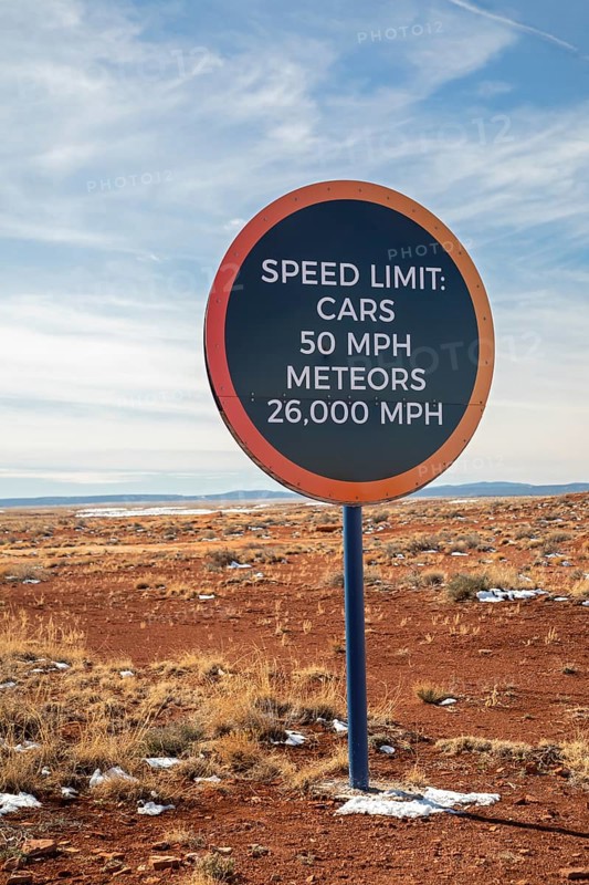 Winslow, Arizona - A speed limit sign on the road to Meteor Crater. The crater was formed about 50, 000 years ago. It is 560 feet deep and abouat three-quarters of a mile in diameter. It is now a major tourist attraction
