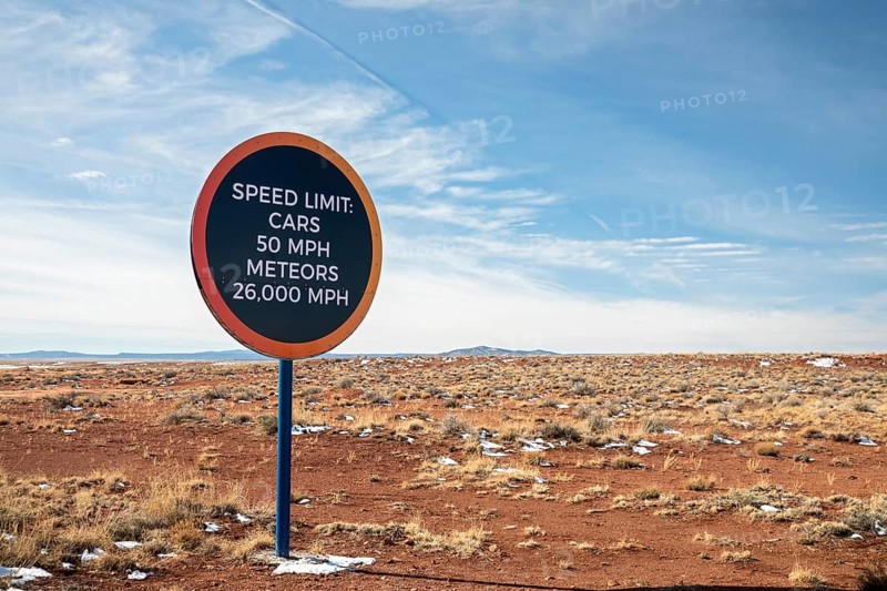 Winslow, Arizona - A speed limit sign on the road to Meteor Crater. The crater was formed about 50, 000 years ago. It is 560 feet deep and abouat three-quarters of a mile in diameter. It is now a major tourist attraction